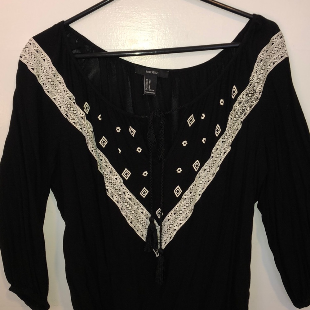 black blouse white detailing with tassels